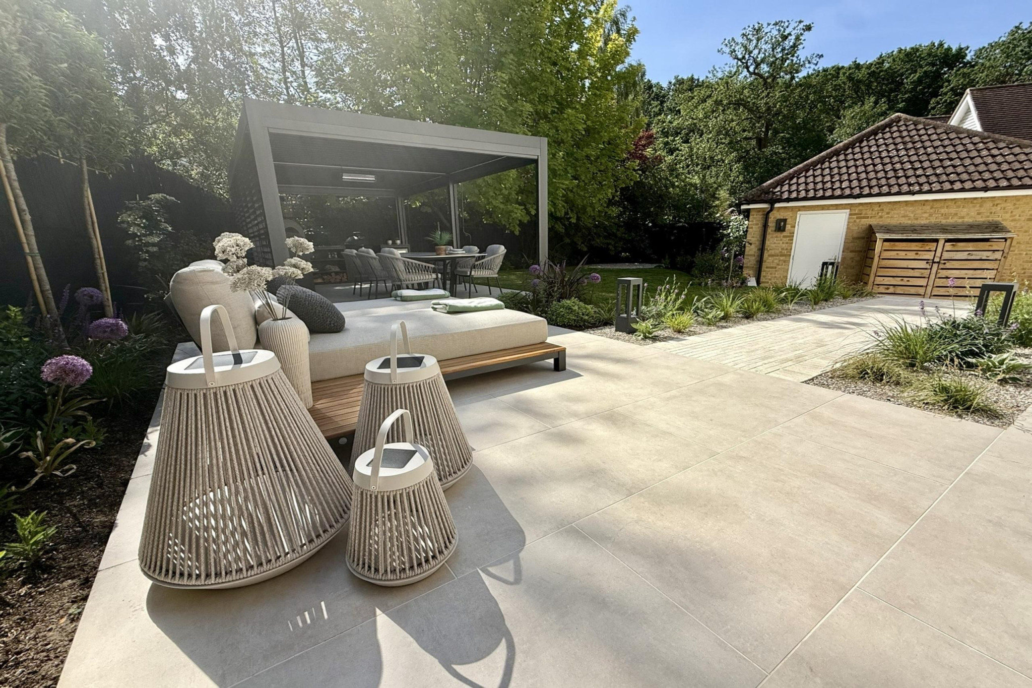 Full garden re-design in Warley, Essex.Low maintenance garden design. Featture paving, near pergola entertainment area with sun loungers and easy to maintain borders.